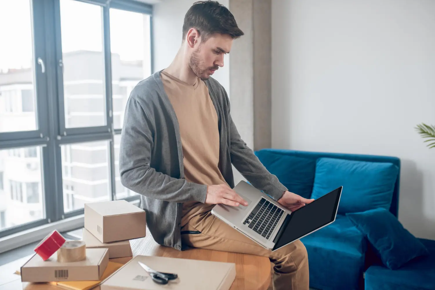 A man working with a laptop for configuration for new IT relocation