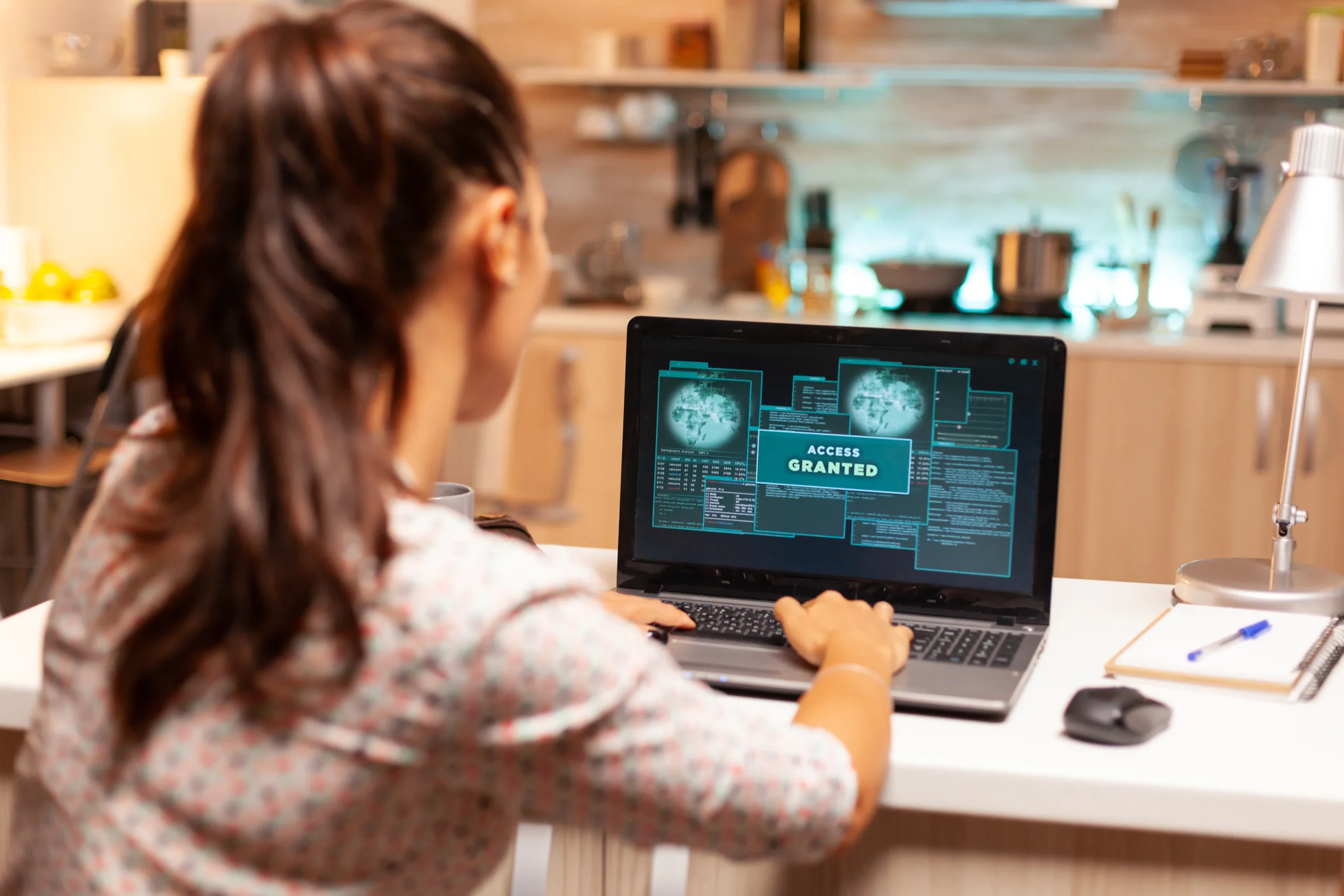 A woman working on a laptop as a vCISO working with Zero Trust