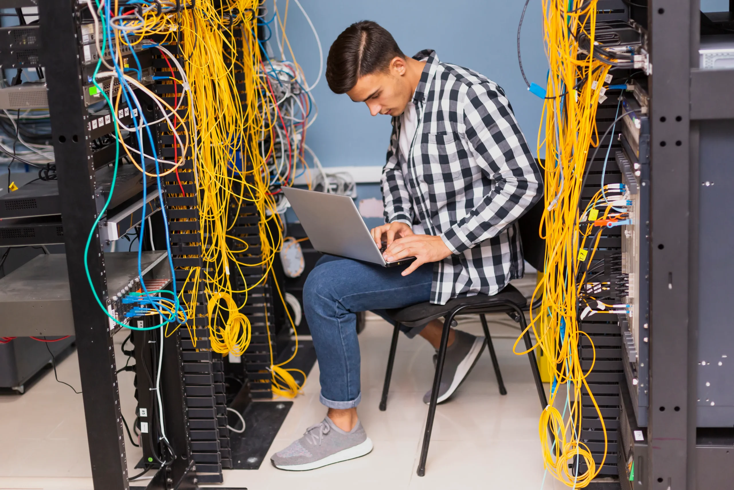 a certified CompTIA Network Engineer working on cable management